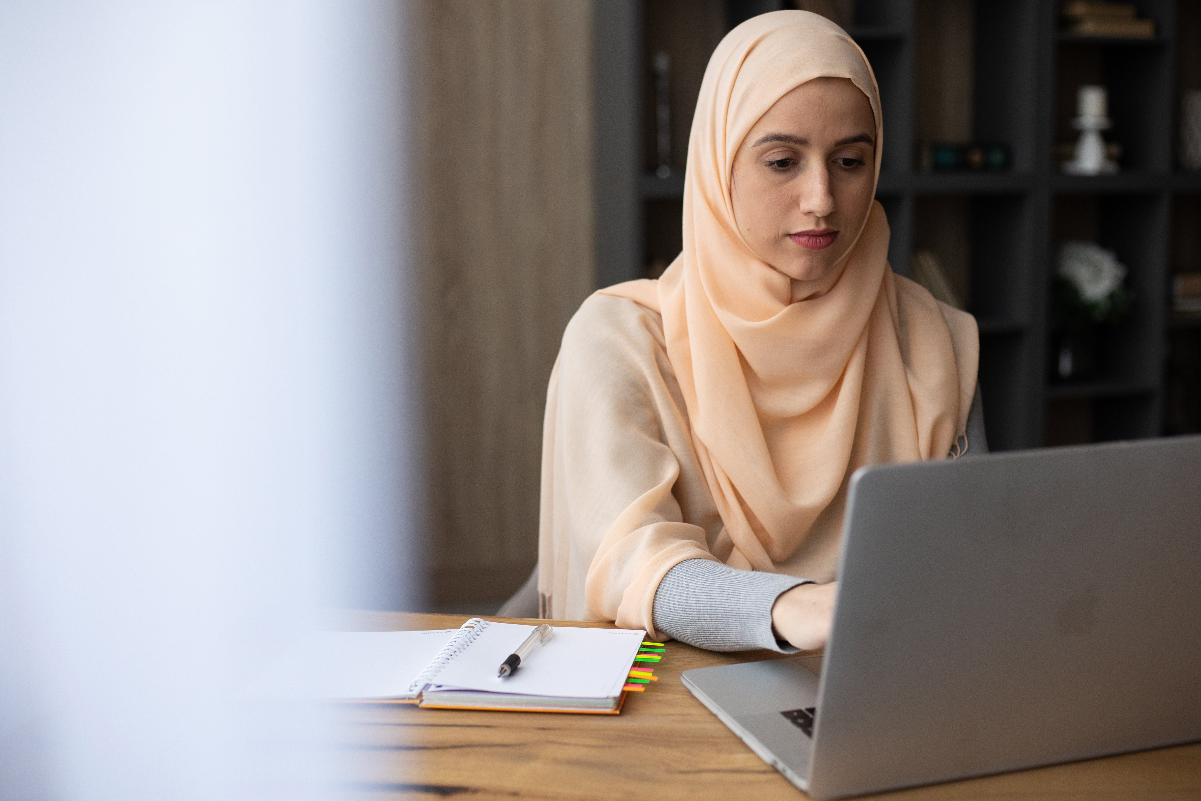 A woman sitting with a laptop
