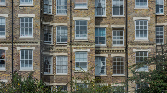 A front facing image of an apartment block's windows