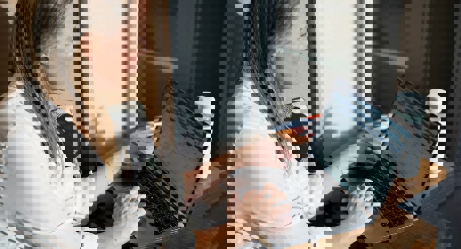 A lady sitting looking at a computer